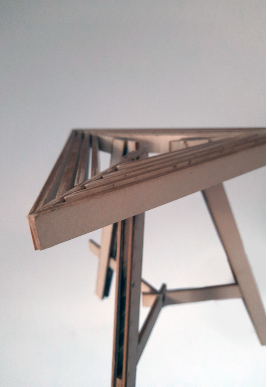 Close view of the slatted seat and the connection points of the stool frame